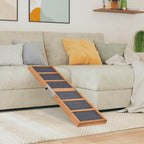 Dog ramp on a carpeted floor in a living room with a couch and colorful pillows.