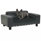 Dog lying on a dark grey dog sofa with studded details on a white background