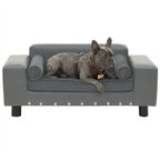 Dog lying on a gray dog sofa with a white background