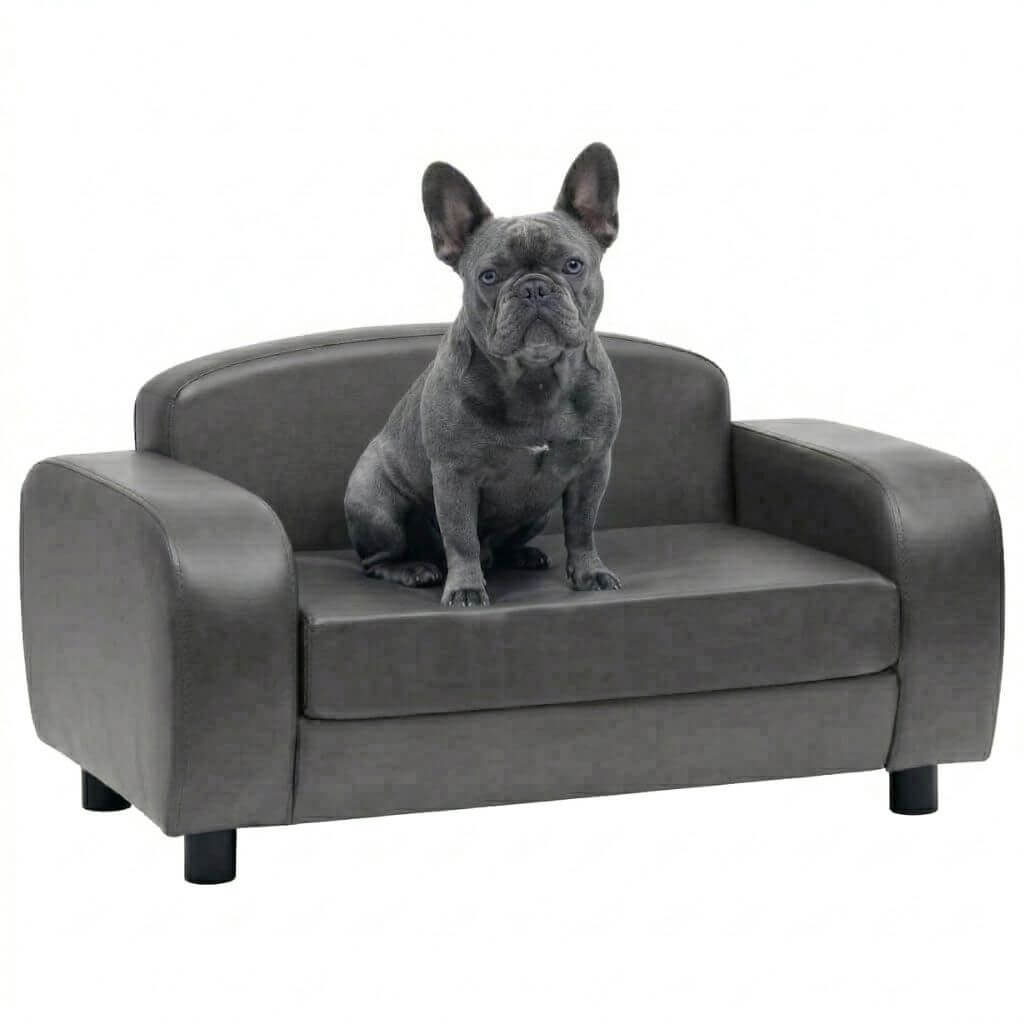 Dog sitting on a gray pet sofa against a white background