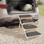 Foldable Dog Steps Grey Solid Wood Pet Stair by DomusDog beside car trunk on gravel driveway