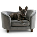 Dog lying on a luxury gray pet sofa with a white background