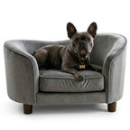 Dog lying on a luxury gray pet sofa with a white background